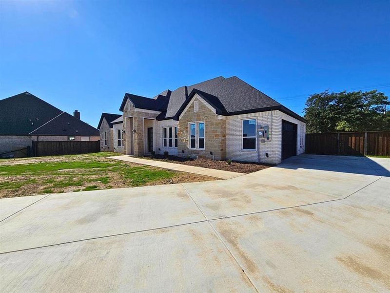 Front exterior of a new home in , Weatherford, TX, highlighting curb appeal (Image 1).