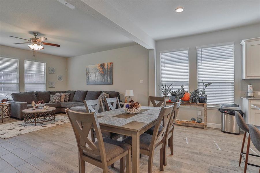 Dining area with light wood-style floors, beamed ceiling, and ceiling fan Dining area with light wood-style floors, beamed ceiling, and ceiling fan