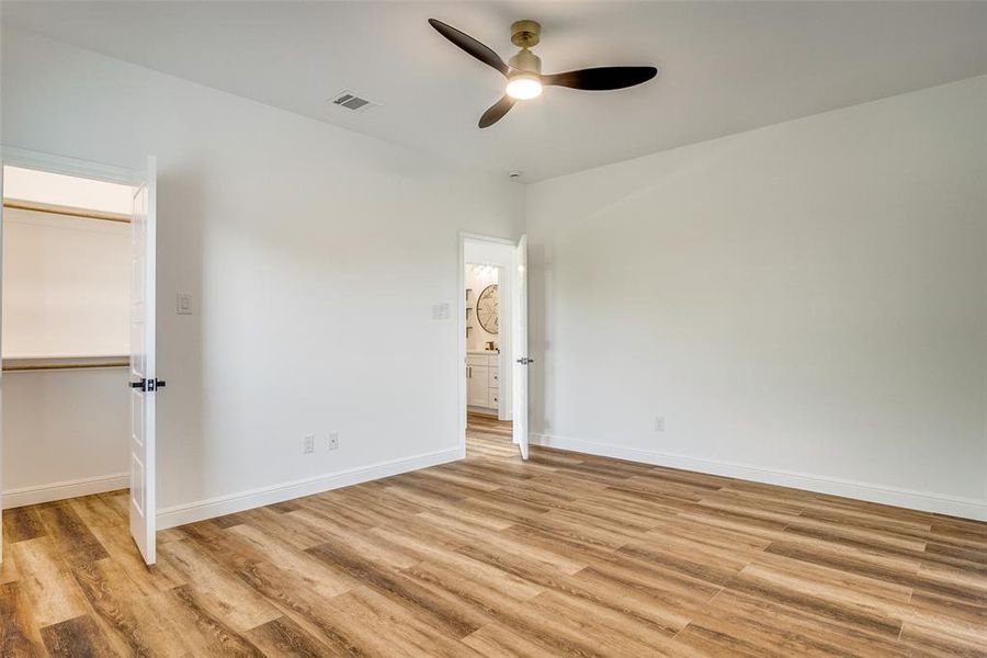 Unfurnished bedroom featuring light wood finished floors and ceiling fan