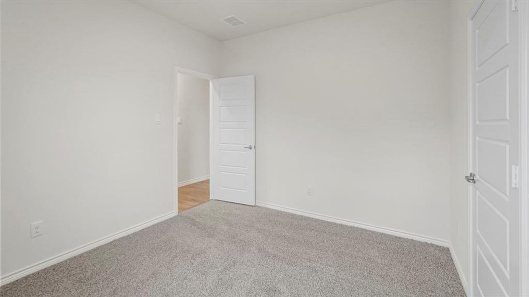 Spare room with carpet floors and baseboards Spare room with carpet floors and baseboards