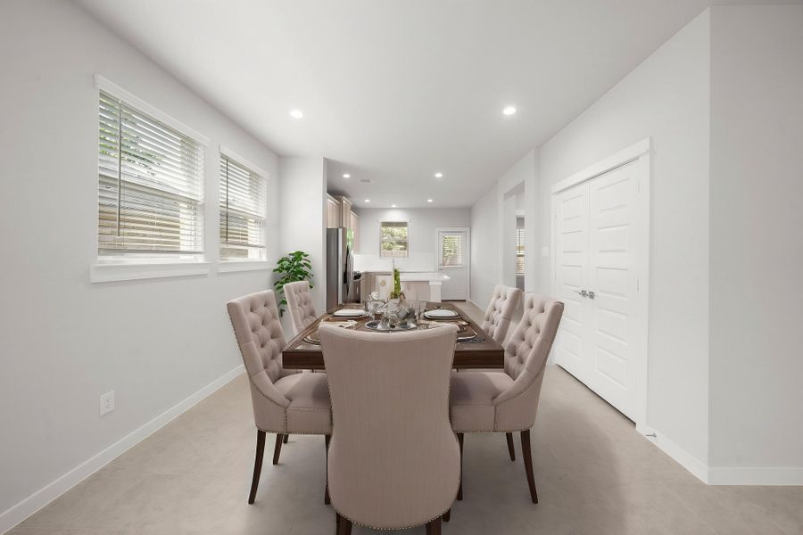 A dining room with a table and chairs.