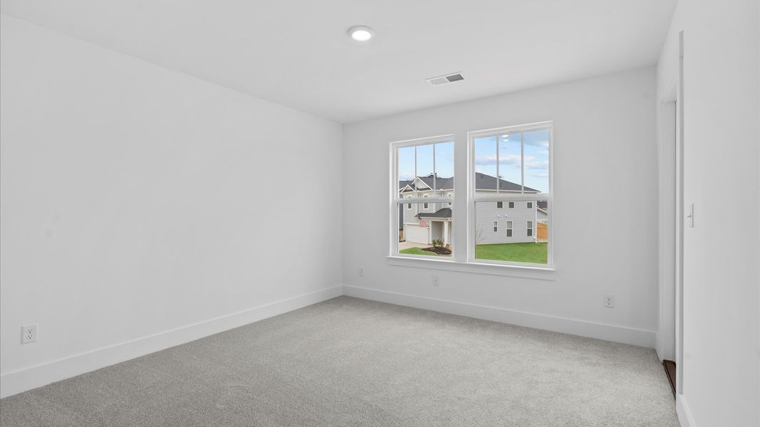 First-class bedroom with generous proportions, a walk-in closet, and beautiful natural light through large windows