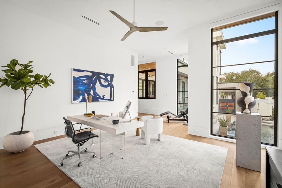 [1st-Floor En Suite Bedroom/ Flexible Space] Furnished a study, this space would also serve as a pool/gameroom with pool bath.