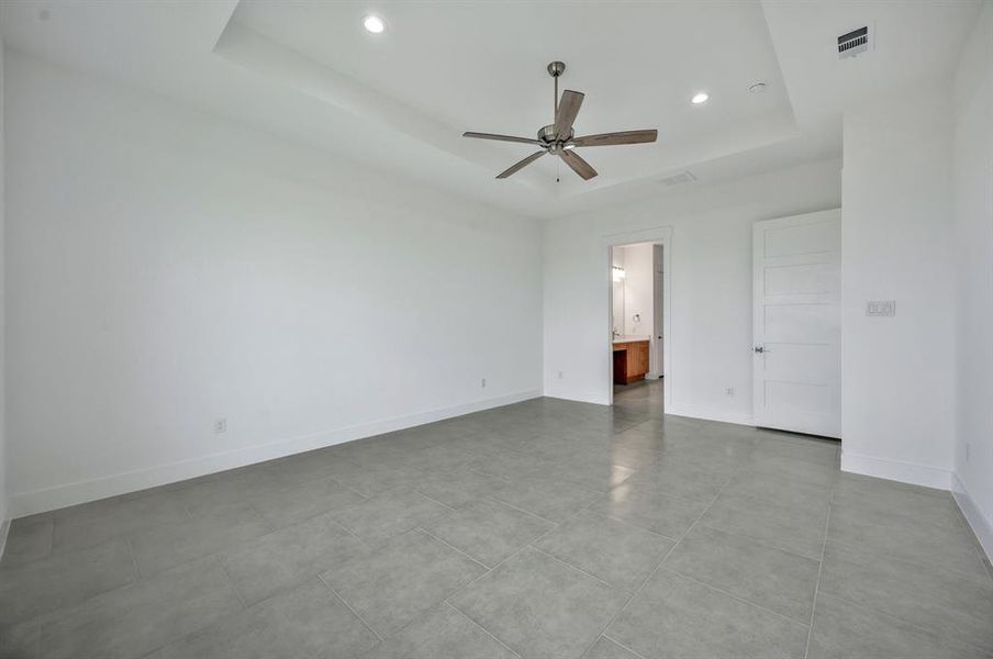 Huge bedroom with ceiling fan and ceramic tile floors Huge bedroom with ceiling fan and ceramic tile floors