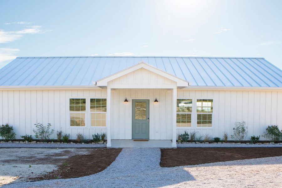 View of front of home featuring a standing seam roof, a metal roof, and board and batten siding View of front of home featuring a standing seam roof, a metal roof, and board and batten siding