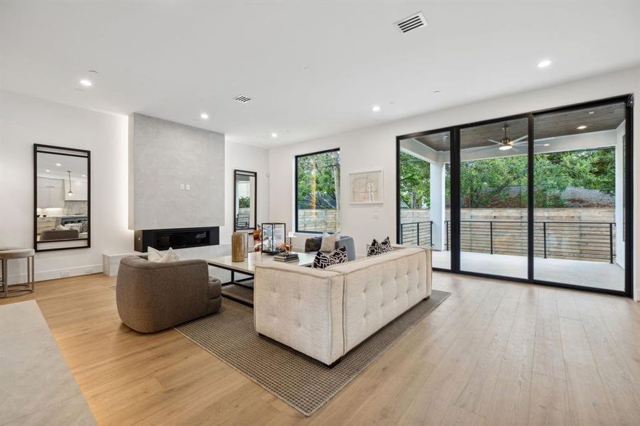 This spacious, modern living room with an open floor plan is filled with natural light from the picture windowsand 12' x 10' RAM sliding glass doors that lead to your outdoor patio.