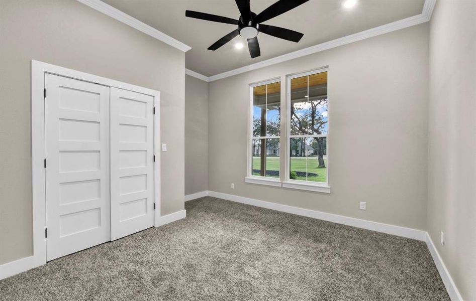 Unfurnished bedroom featuring crown molding, carpet floors, a closet, a ceiling fan, and recessed lighting