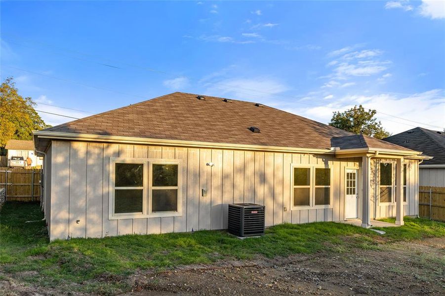 Rear view of property featuring a shingled roof and board and batten siding