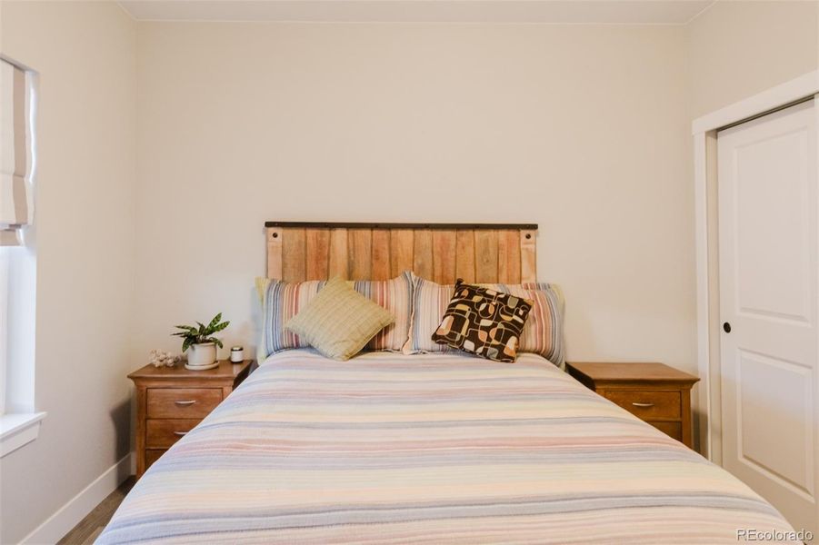 The second main-floor bedroom has a double closet and lots of natural light, plus room for a queen-sized bed and furnishings. The second main-floor bedroom has a double closet and lots of natural light, plus room for a queen-sized bed and furnishings.