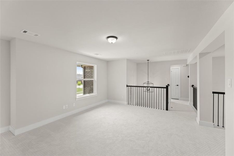 Spare room with light carpet, visible vents, and baseboards Spare room with light carpet, visible vents, and baseboards