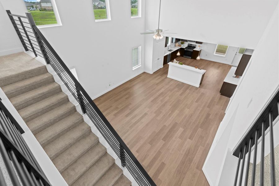 Overlooking the main living area, this view from the second-floor landing shows the soaring ceilings, modern railing, and open-concept design that defines the home’s stylish layout. **Image Representative of Plan Only and May Vary as Built**. Overlooking the main living area, this view from the second-floor landing shows the soaring ceilings, modern railing, and open-concept design that defines the home’s stylish layout. **Image Representative of Plan Only and May Vary as Built**.