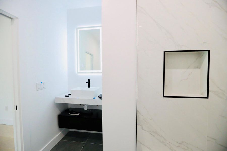 Bathroom with vanity and dark tile patterned floors