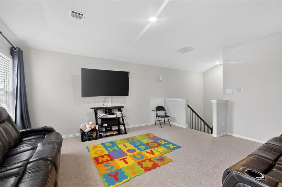 Living area featuring light colored carpet and baseboards Living area featuring light colored carpet and baseboards
