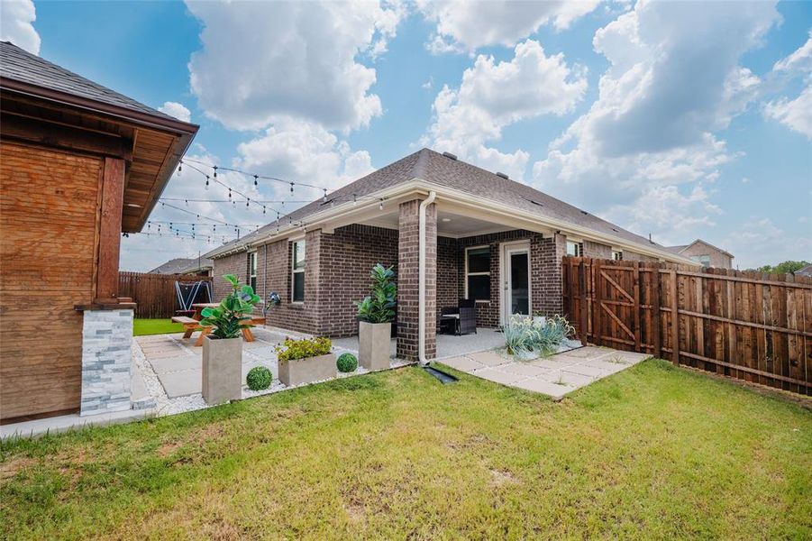 Back of house with a patio area, brick siding, a fenced backyard, and roof with shingles Back of house with a patio area, brick siding, a fenced backyard, and roof with shingles
