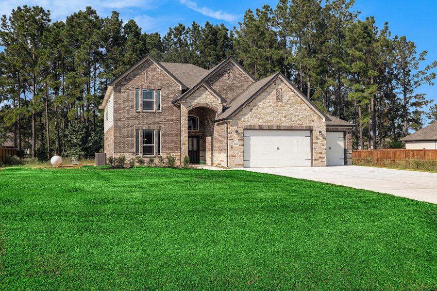 Front exterior of a new home in Deer Pines, Conroe, TX, highlighting curb appeal (Image 17).