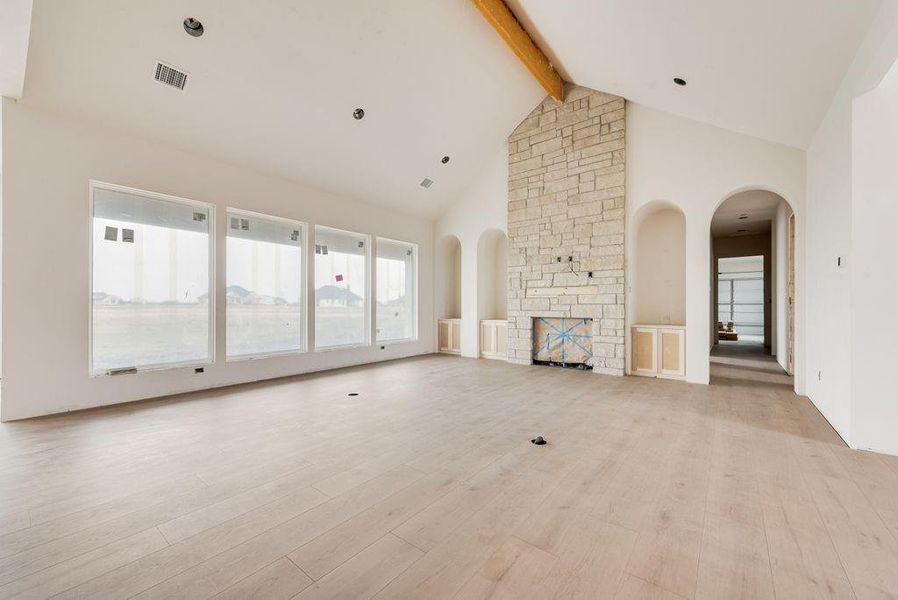 Open Living Space with the statement Fireplace & storage nooks, bank of windows across the back