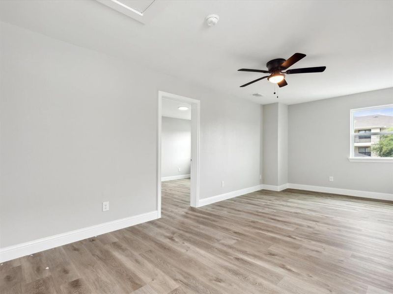 Unfurnished room featuring ceiling fan and light hardwood / wood-style flooring