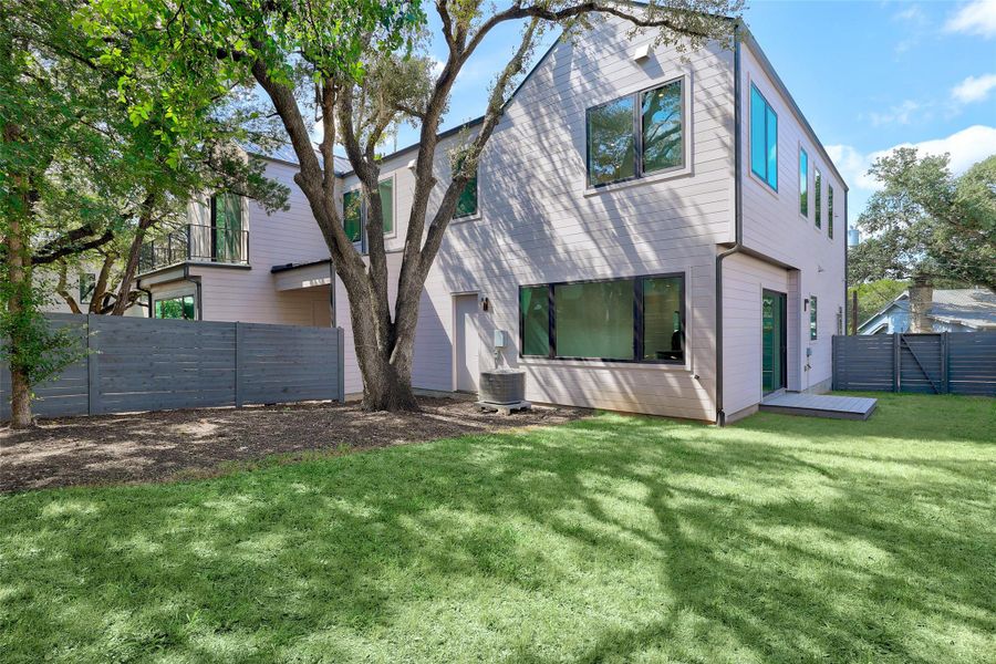 Rear view of property with a fenced backyard