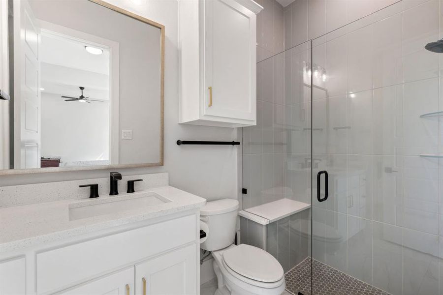 Full bathroom with a stall shower, vanity, and a ceiling fan