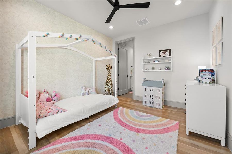 Bedroom featuring oak hardwood floors, wallpapered walls, ceiling fan, and recessed lighting