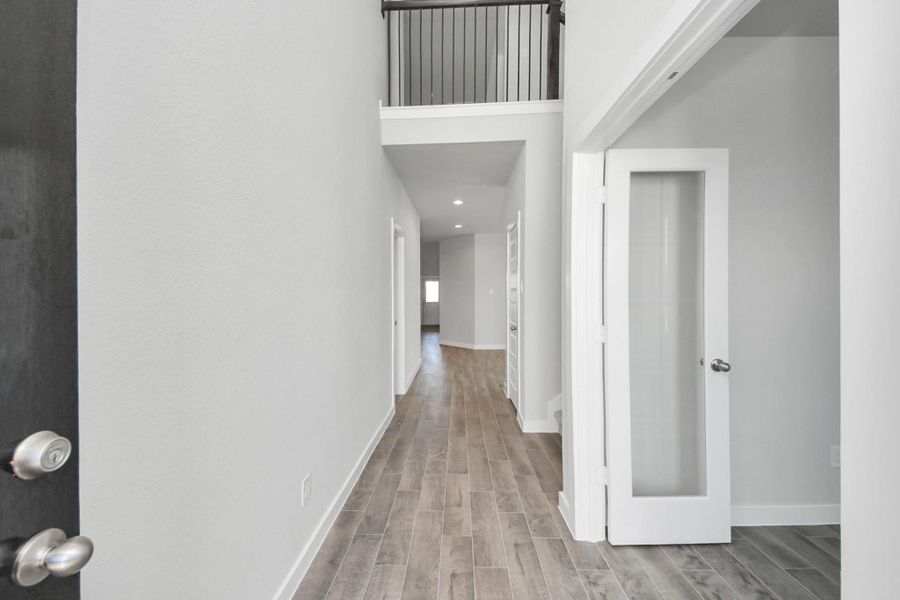 Indulge in luxury as you step into the threshold of this breathtaking home. The grand entrance beckons with its soaring ceilings, adorned with elegant wood-look tile flooring featuring sleek oversized baseboards. Cast your gaze upwards to a mesmerizing view of the open staircase. Follow the path of natural light streaming through expansive windows as you make your way to the family room, creating an inviting and warm atmosphere. Indulge in luxury as you step into the threshold of this breathtaking home. The grand entrance beckons with its soaring ceilings, adorned with elegant wood-look tile flooring featuring sleek oversized baseboards. Cast your gaze upwards to a mesmerizing view of the open staircase. Follow the path of natural light streaming through expansive windows as you make your way to the family room, creating an inviting and warm atmosphere.