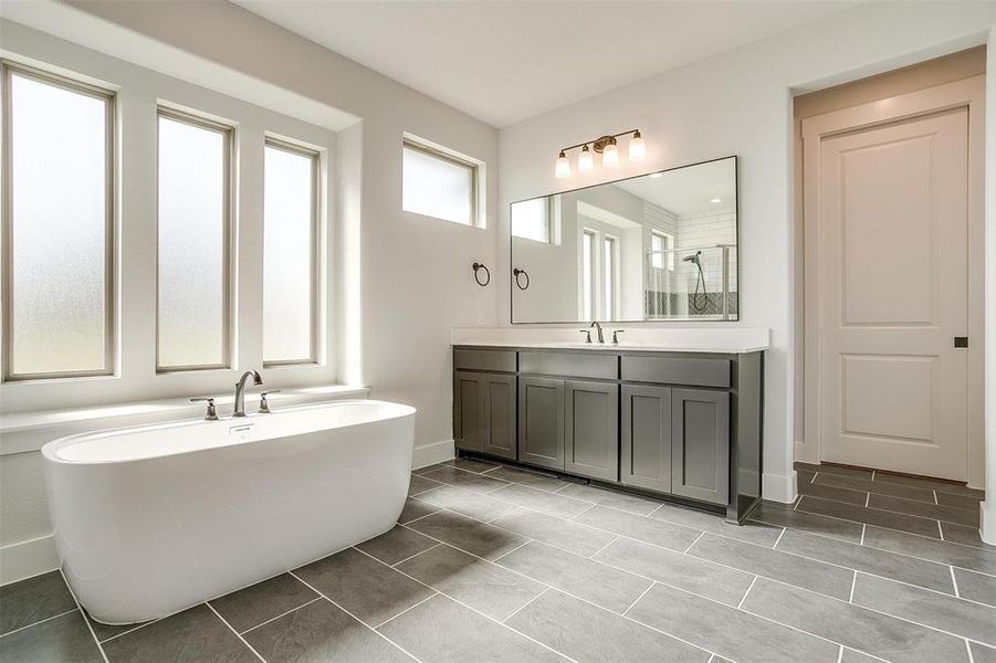 Bathroom featuring vanity, plus walk in shower, and tile patterned floors