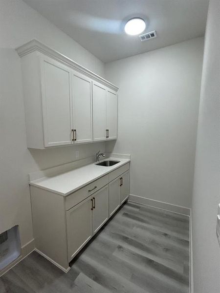 Utility room with cabinet and sink