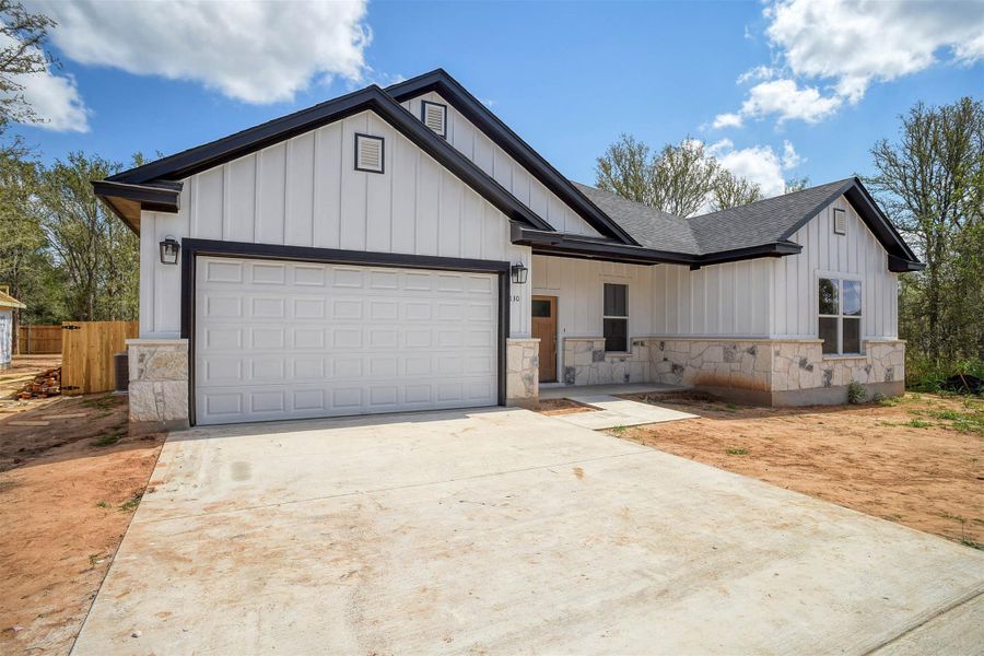 Front exterior of a new home in , Bastrop, TX, highlighting curb appeal (Image 2).