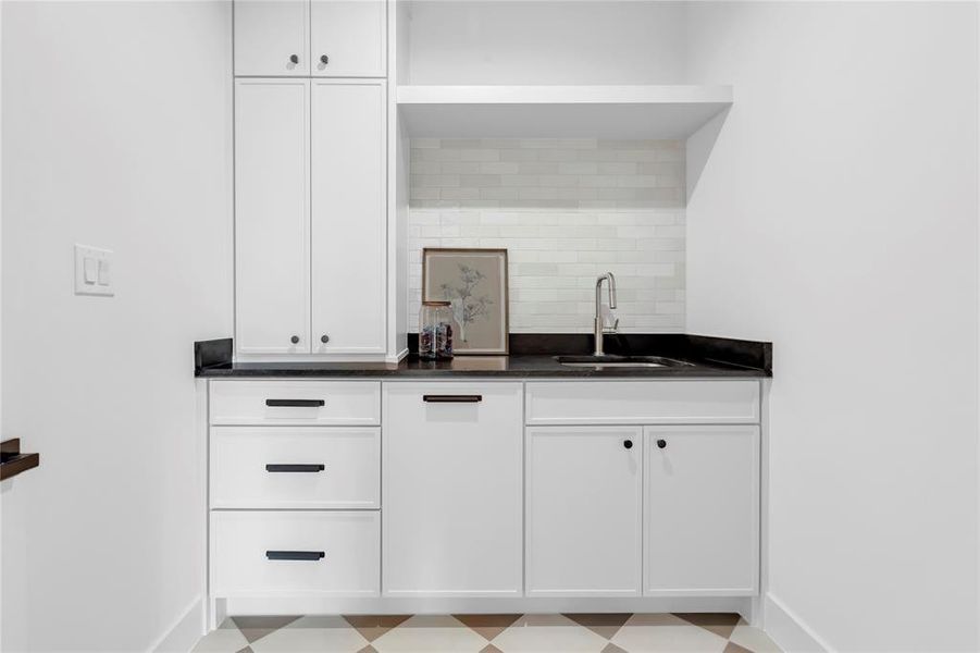 Bar with white cabinets, light flooring, and open shelves Bar with white cabinets, light flooring, and open shelves