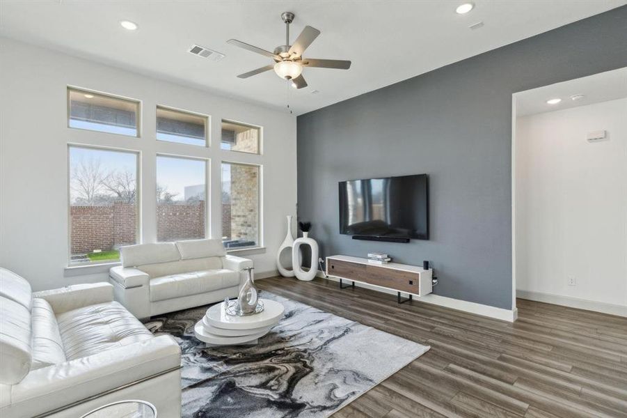 Living area with recessed lighting, dark wood-type flooring, and a ceiling fan Living area with recessed lighting, dark wood-type flooring, and a ceiling fan