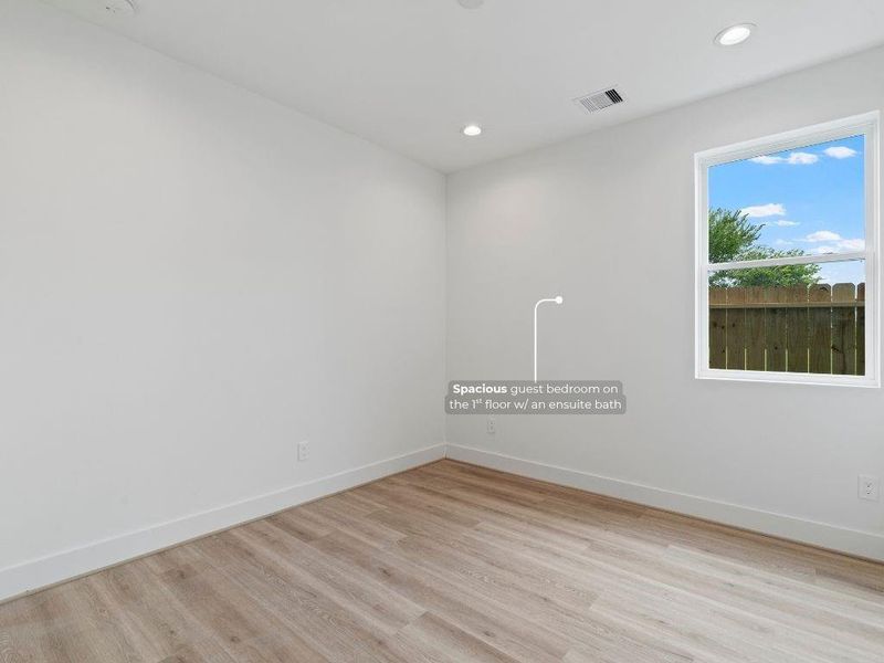 Spacious guest bedroom featuring a private ensuite bath with a walk-in shower.