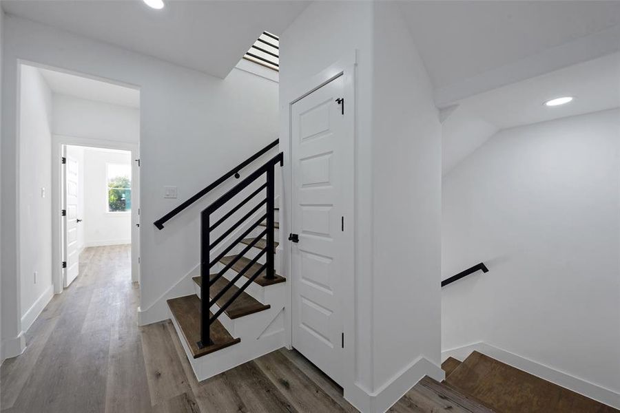 The stairway from the main floor brings you to the second floor - there are two bedrooms with ensuite baths, including the primary suite.