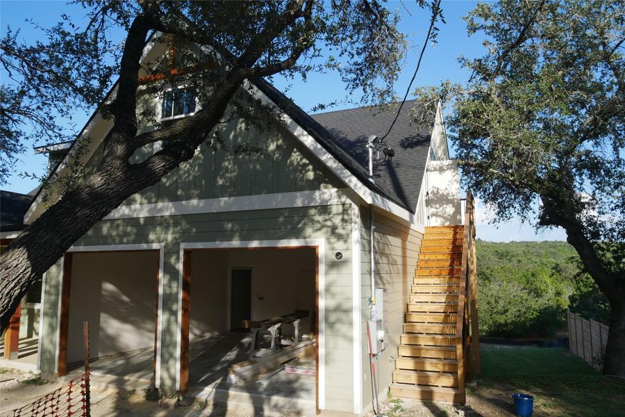 Two-car garage with exterior stair access to private upstairs living area. Two-car garage with exterior stair access to private upstairs living area.