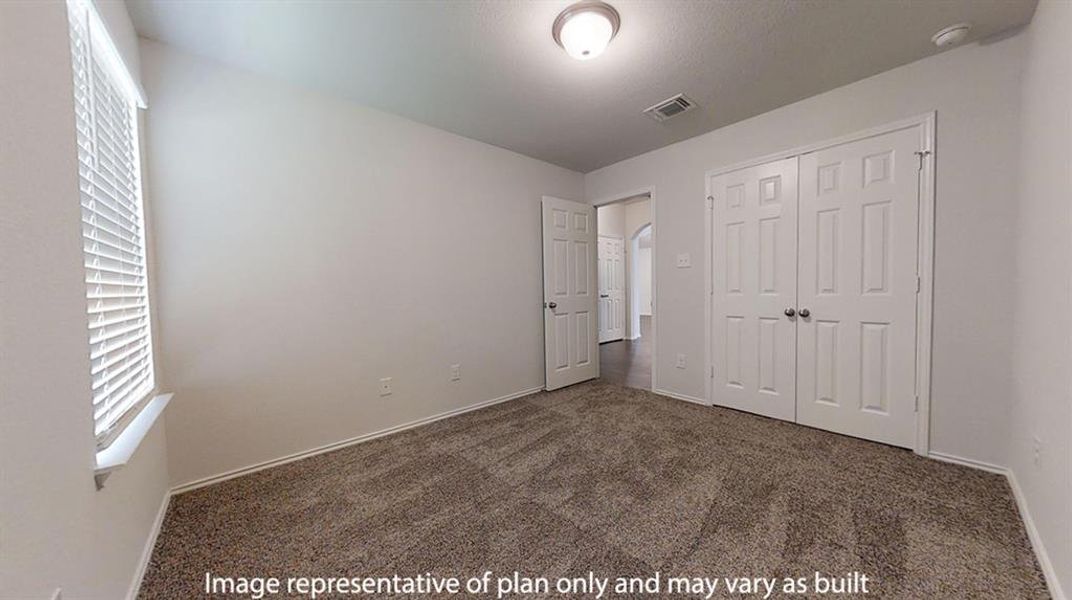 Unfurnished bedroom with dark carpet and a closet Unfurnished bedroom with dark carpet and a closet