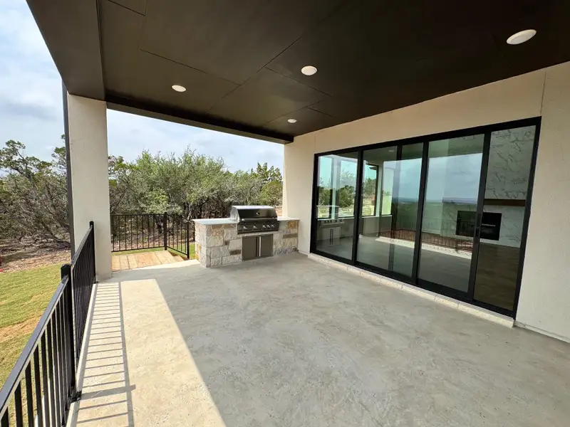 Exterior details and patio area of a home in The Hollows Sanctuary - 85', Jonestown (Image 3). Exterior details and patio area of a home in The Hollows Sanctuary - 85', Jonestown (Image 3).