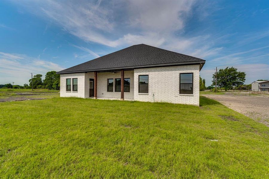 Rear view of property featuring a yard