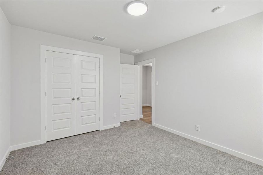 Bedroom in the Harrison home plan by Trophy Signature Homes – REPRESENTATIVE PHOTO