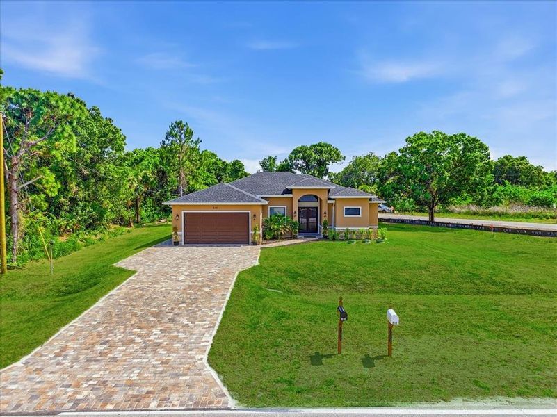 Front exterior of a new home in , Lehigh Acres, FL, highlighting curb appeal (Image 22).