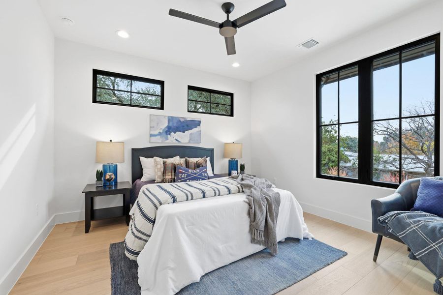 Bedroom with light wood-type flooring, recessed lighting, and a ceiling fan