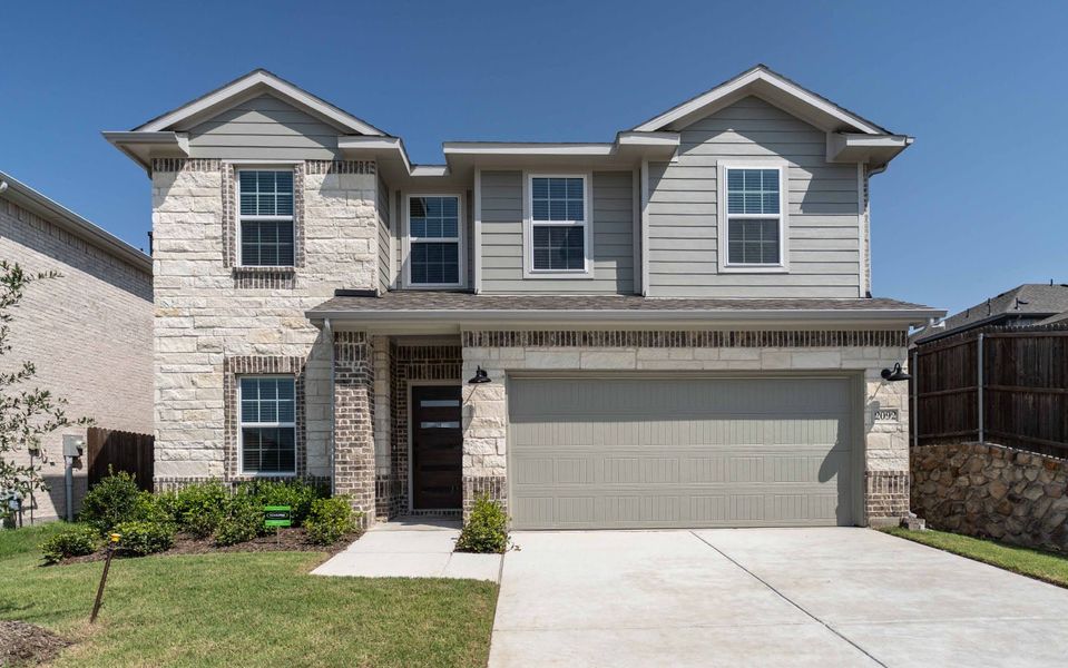 Front exterior of a new home in Travis Ranch, Forney, TX, highlighting curb appeal (Image 1). Front exterior of a new home in Travis Ranch, Forney, TX, highlighting curb appeal (Image 1).