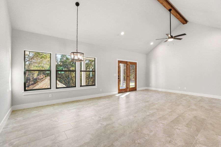 A spacious room with tall vaulted ceilings and broad windows offers inviting views of the outdoors. A spacious room with tall vaulted ceilings and broad windows offers inviting views of the outdoors.