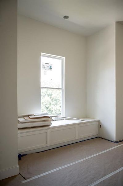 We love our custom carpentry and the game room/flex area does not disappoint with these pull out built ins and bench under the window.