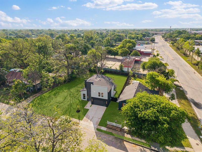 This property features a contemporary architectural style with a two-car garage and a paved driveway This property features a contemporary architectural style with a two-car garage and a paved driveway
