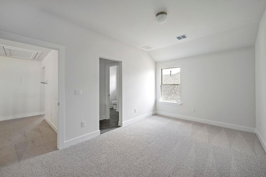 Unfurnished bedroom with baseboards, carpet, and attic access