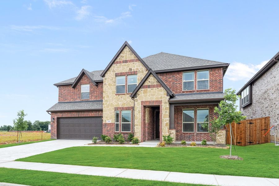 Two-story home with brick and stone exterior, two-car garage, and manicured front lawn Two-story home with brick and stone exterior, two-car garage, and manicured front lawn