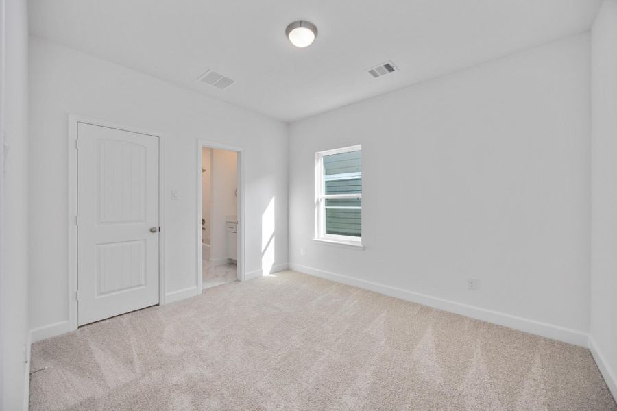 A secondary bedroom with ensuite vibes. Ideal for guests, roommates, or your favorite teenager who wants a little space of their own.