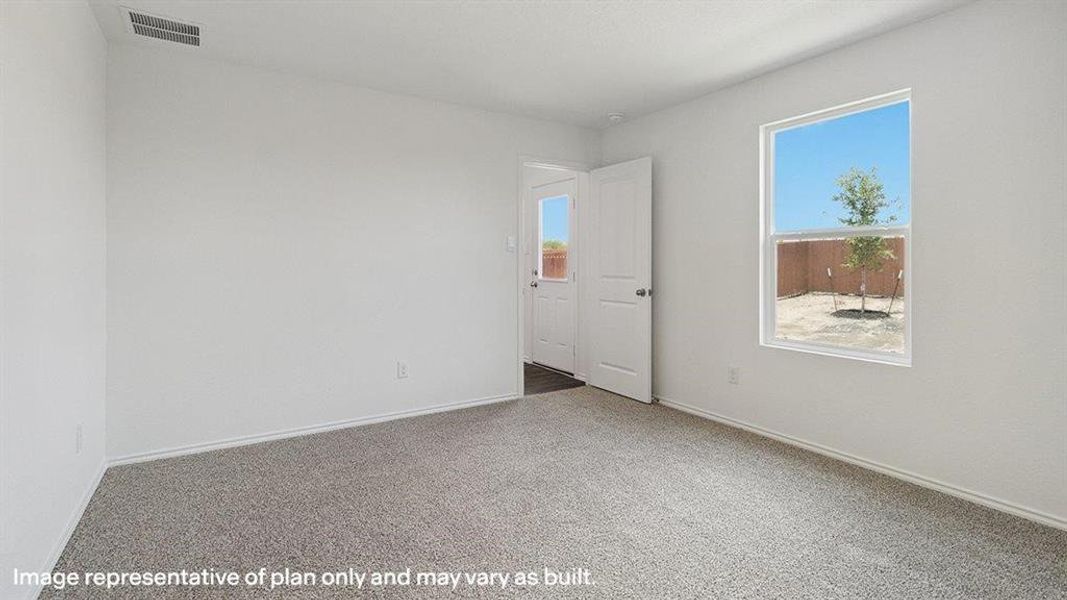 Empty room with carpet floors and healthy amount of natural light