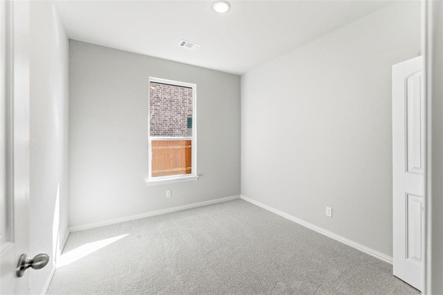Carpeted empty room featuring baseboards