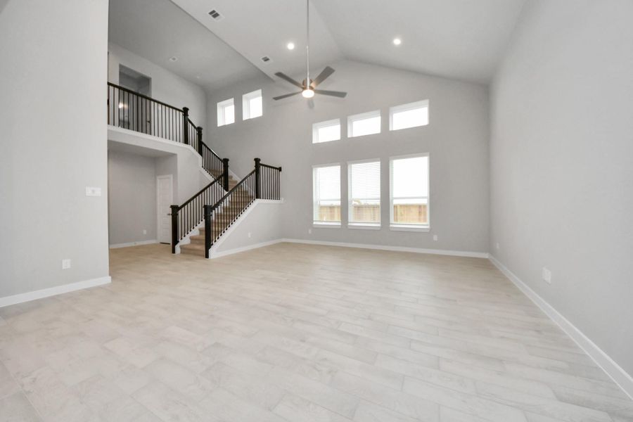 Gather the family and guests together in your lovely living room! Featuring soaring highceilings, recessed lighting, ceiling fan, custom paint, gorgeous floors, and large windows thatprovide plenty of natural lighting throughout the day. Sample photo of completed home with similar floor plan. Actual colors and selections may vary. Gather the family and guests together in your lovely living room! Featuring soaring highceilings, recessed lighting, ceiling fan, custom paint, gorgeous floors, and large windows thatprovide plenty of natural lighting throughout the day. Sample photo of completed home with similar floor plan. Actual colors and selections may vary.