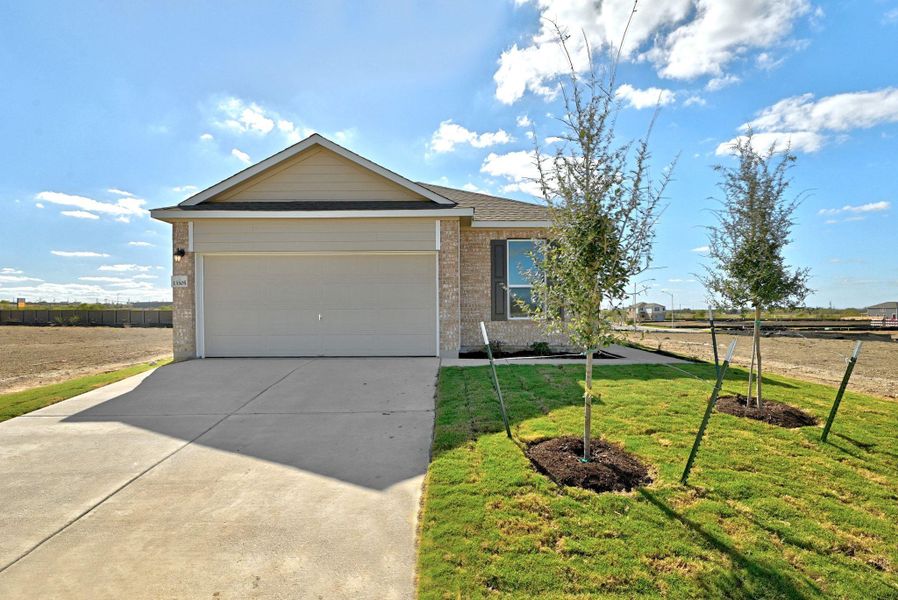 Front exterior of a new home in Stoney Chase, Del Valle, TX, highlighting curb appeal (Image 1). Front exterior of a new home in Stoney Chase, Del Valle, TX, highlighting curb appeal (Image 1).